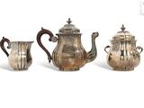 three pieces of silver tea and coffee set on a white background