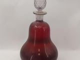 an image of a red glass perfume bottle with a glass stopper