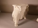 a white elephant with a basket on it ' s back