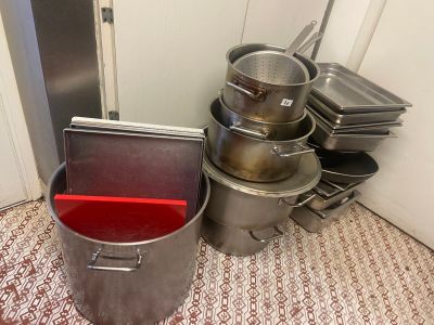 many pots and pans sitting on the floor next to each other
