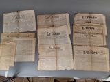 many old newspapers sitting on a table on the table