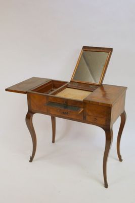 a small wooden table with a mirror on top of it