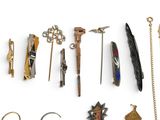 many different types of jewelry on display on a white surface