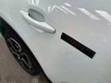 a close up of a car door handle with a sticker on it