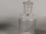 two small glass bottles that are sitting on a table