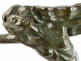 statue of a woman laying on her back with her arms outstretched