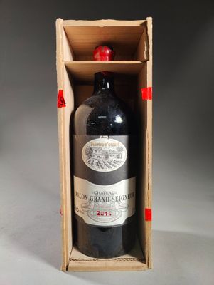a bottle of wine in a wooden box on a table