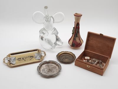 a small assortment of silver and glass items on a table