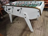 a foosball table in the middle of a living room