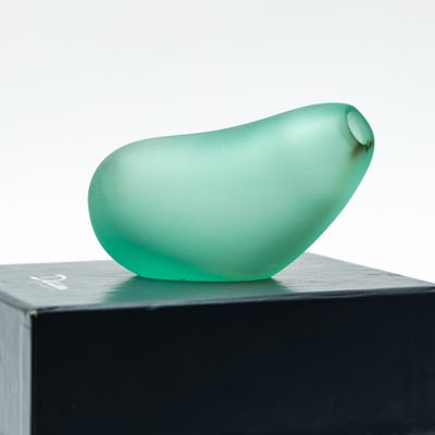 a glass figurine sitting on top of a black box