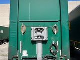 a green trailer that is parked in a parking lot