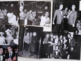 several black and white photos of a group of people hanging on a wall