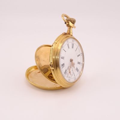 gold plated pocket watch with roman numerals and roman numerals