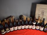 several bottles of wine are lined up on a table