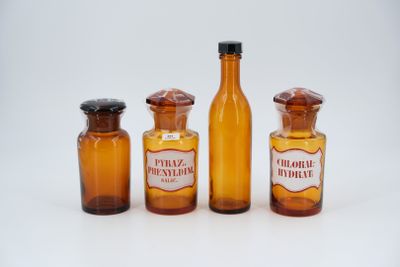 bottles of medicine are lined up in a row on a white surface