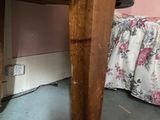 a cat that is sitting under a table in a room