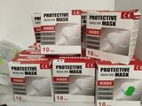 several boxes of protective masks are stacked on top of each other