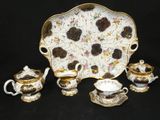 a picture of a tea set on a black background