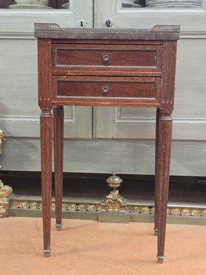a small wooden table with a drawer on top of it