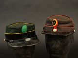 pair of hats on mannequin heads on a black background