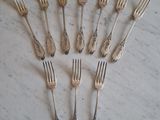 a lot of forks that are sitting on a table