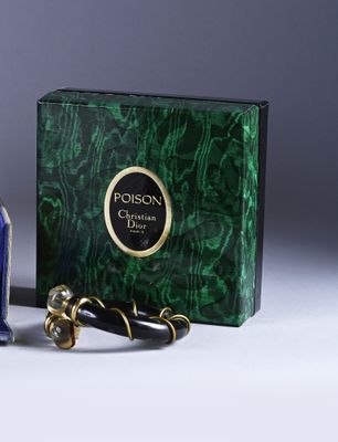 a bottle of perfume next to a box of perfumes