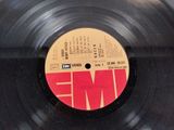 an old record with a label on it sitting on a table