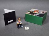 a small figurine of a cowboy sitting on a chair next to a box