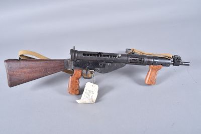 an old toy gun with a wooden handle and a tag on it