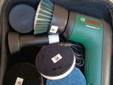 a bag with a hair dryer, sponges, and a brush in it