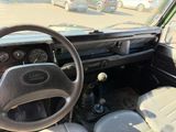 a dashboard and steering wheel of a car in a parking lot