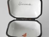 a small white box with an orange design on it