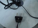 a picture of a black power cord plugged into a white table