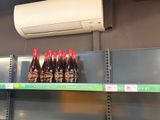 many bottles of beer on the shelves in the store