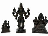three figurines of hindu deities on a white background