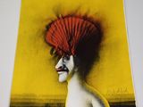 an open book with a picture of a woman with a red hat on her head
