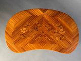a wooden table with a flower design on it
