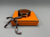 an orange box with a black belt and a silver buckle