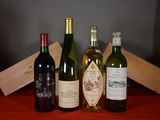 several bottles of wine are lined up on a red table