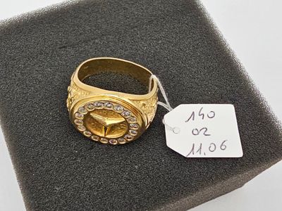 a gold ring with a diamond on top of a black box