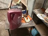 une petite table sur laquelle se trouve un récipient rose