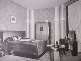 a black and white photo of a bedroom with a large bed