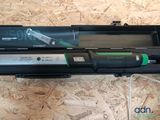 a green and black electric toothbrush in a black case