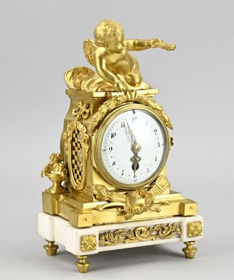a gold clock with an angel on top of it