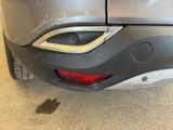 the rear end of a car with a denting dent on it