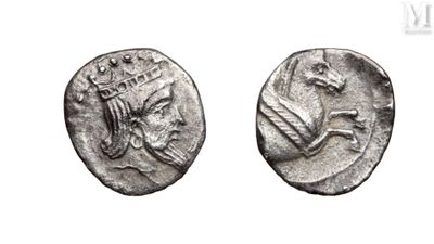 two ancient silver coins with a crown on top of them