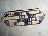 a metal sign that says alto on the side of a building