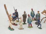 many figurines of different types of soldiers on a white surface
