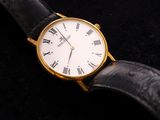 a close up of a watch with roman numerals on it