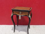 dollhouse miniature table with tassels on top of it in front of a red wall